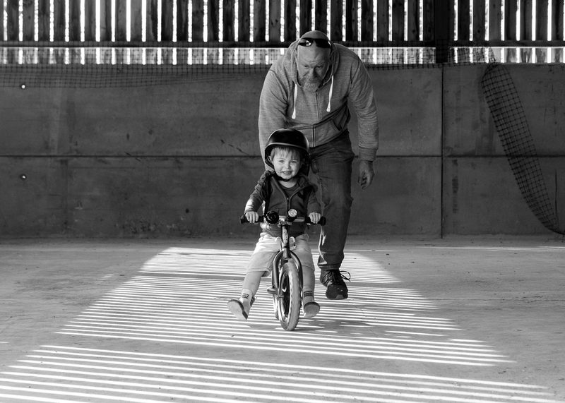 Chris teaching Tay to ride a bike